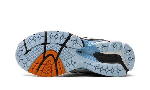 "Close-up of New Balance 1906R logo and mesh details – White Black Copper"